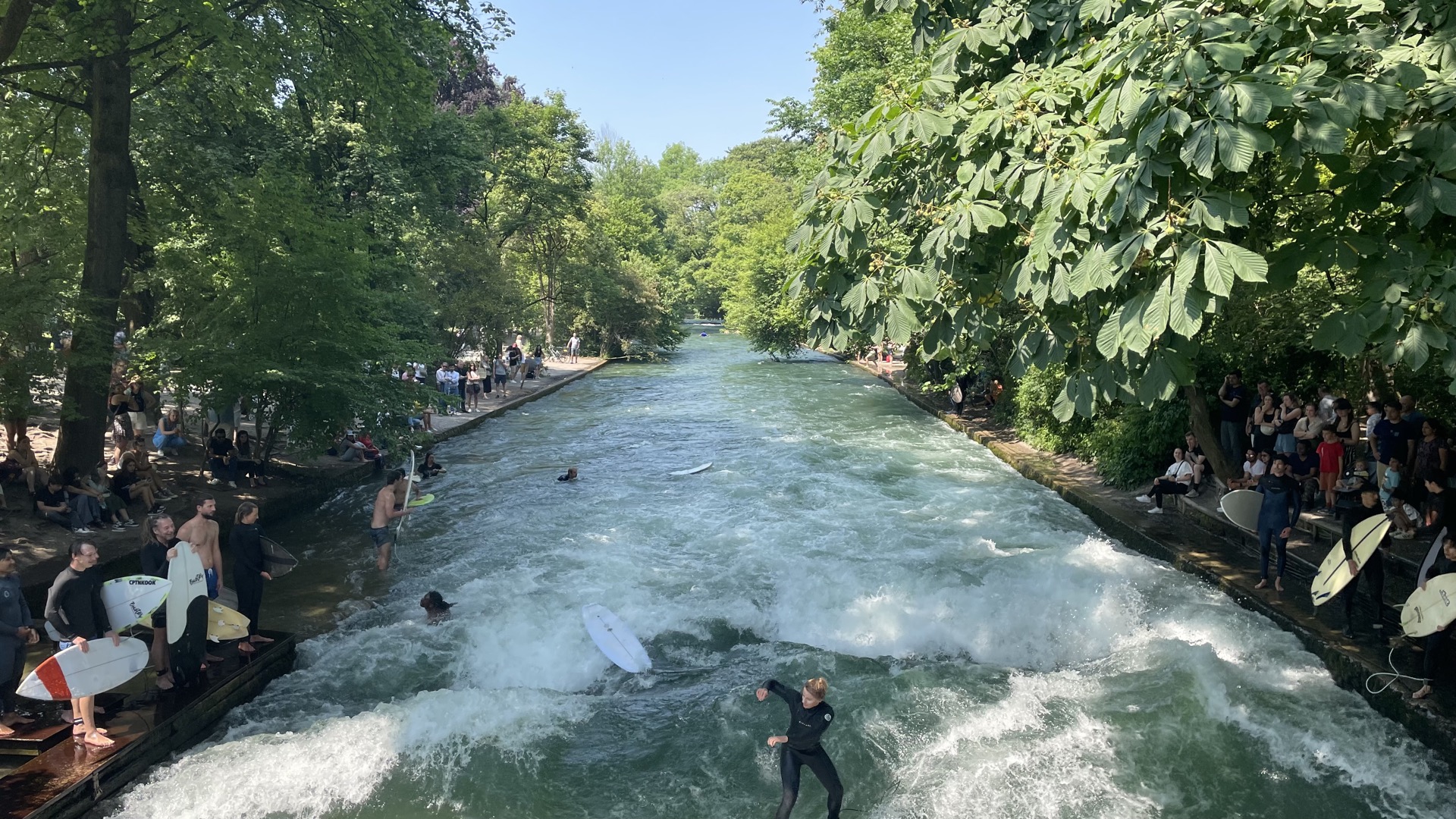 Surfer riding the Eisbach standing wave, Munich, Germany
