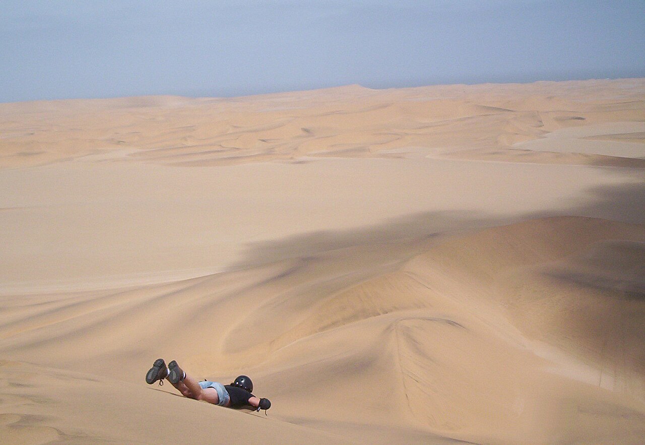 Sandboarding on the dunes near Swakopmund, Namibia