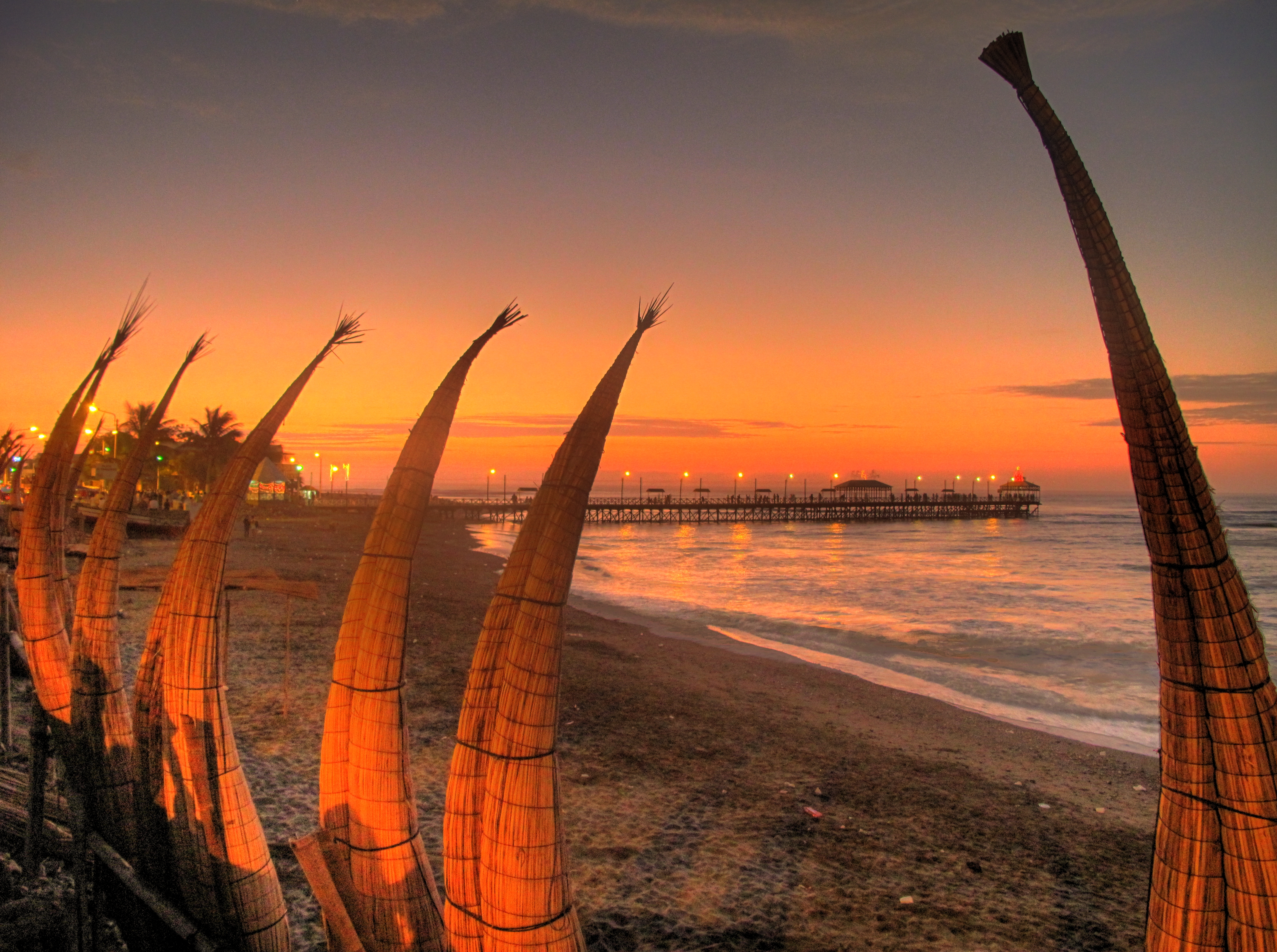 Sunset over Huanchaco with traditional caballitos de totora reed boats