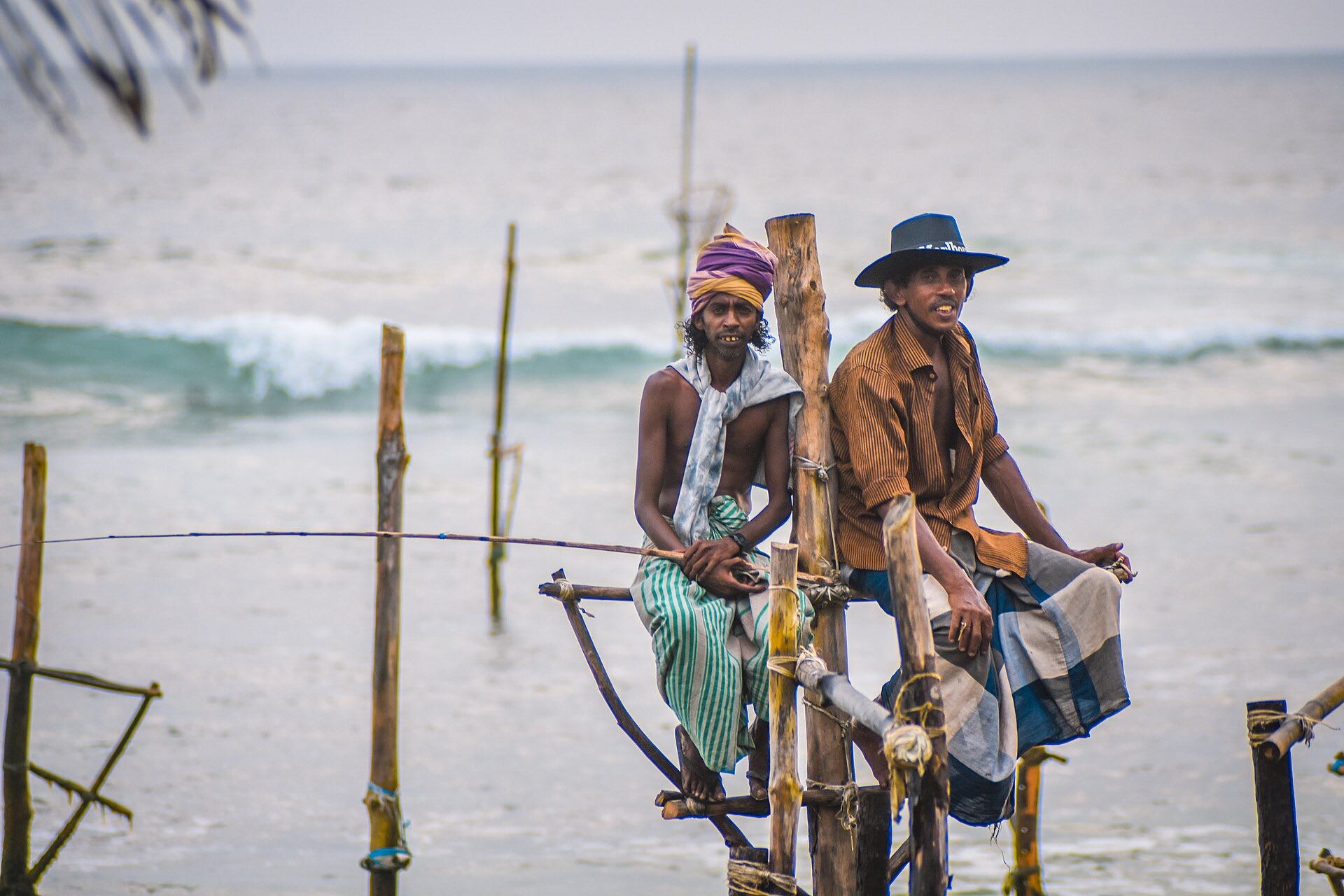 Traditional stilt fishermen on poles off the southern coast of Sri Lanka