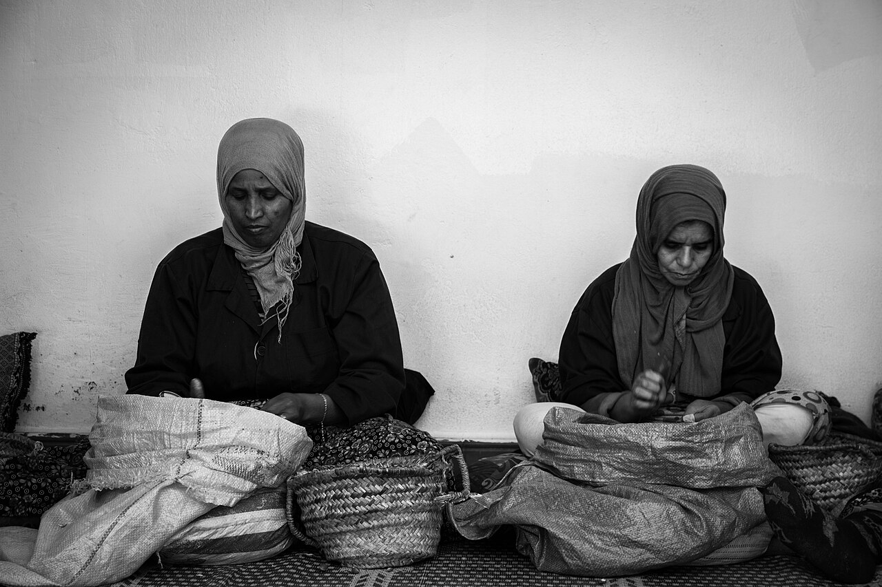Women cracking argan nuts by hand at a cooperative in southwestern Morocco