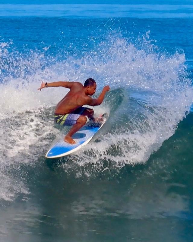 Wayan Dedi surfing a wave