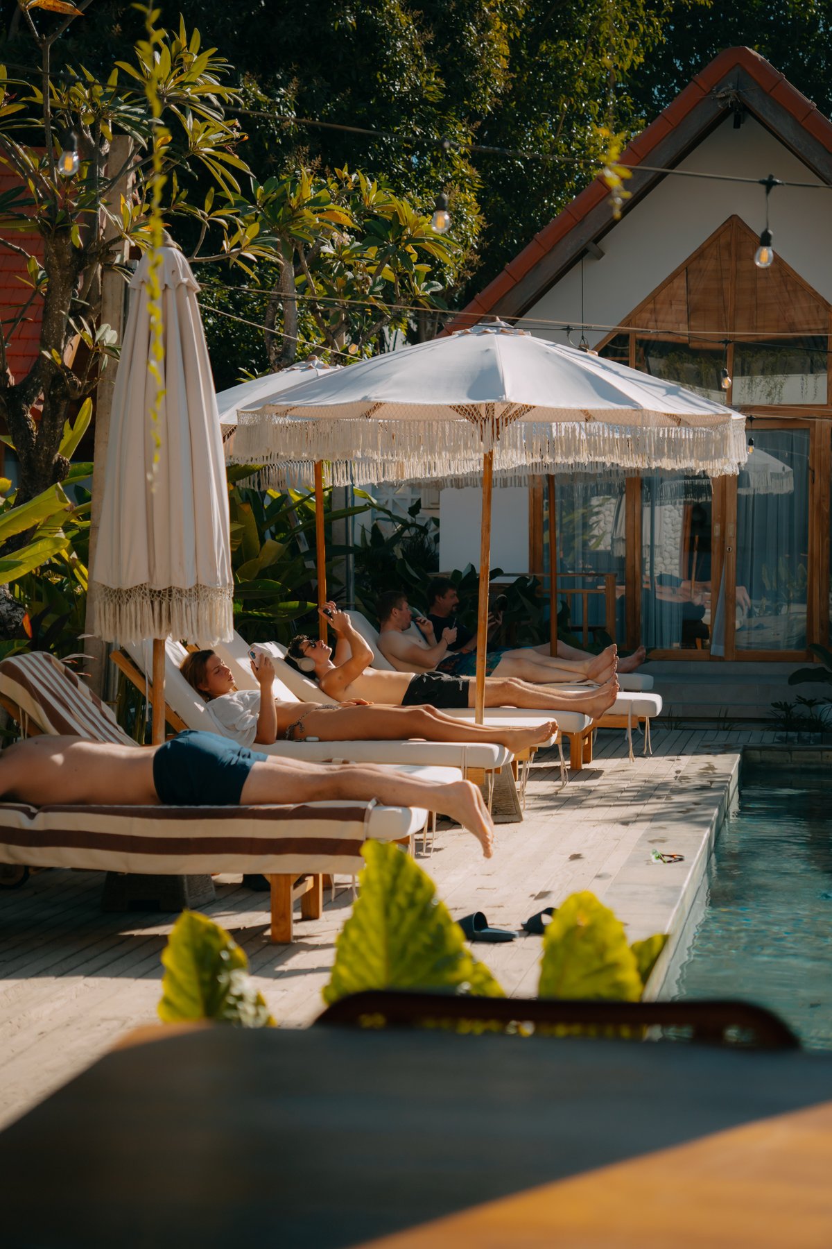 Guests relaxing poolside at CARI Surf Camp