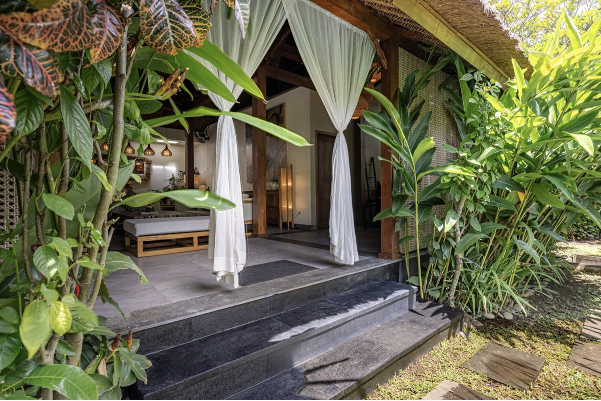 Karmagali villa entrance with sheer curtains opening onto the living area
