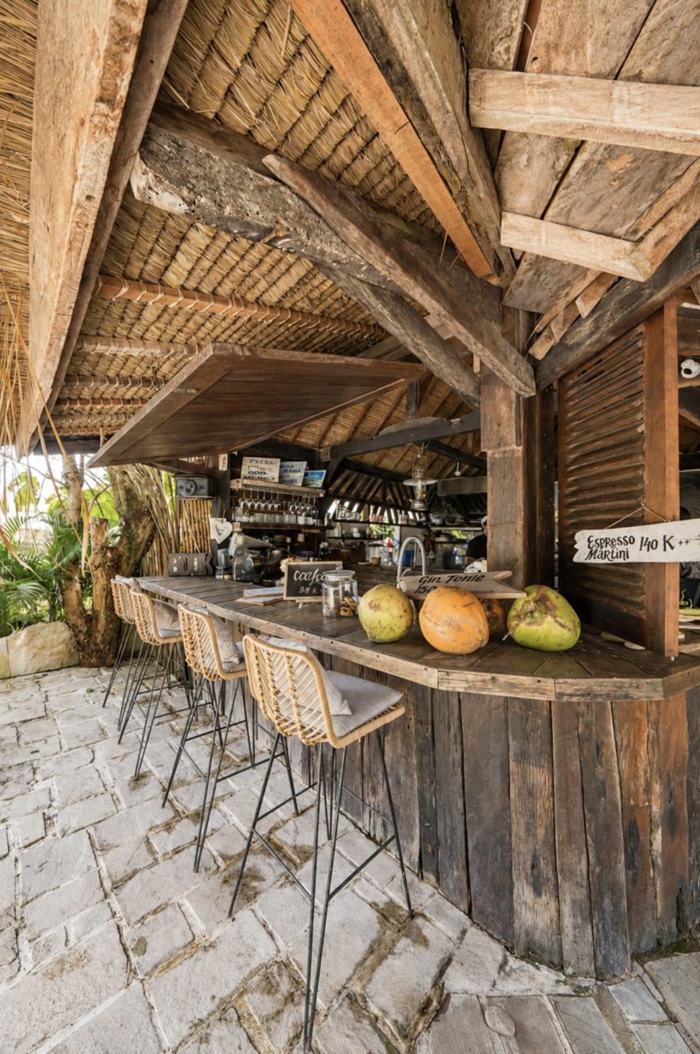 Thatched-roof poolside bar with fresh coconuts