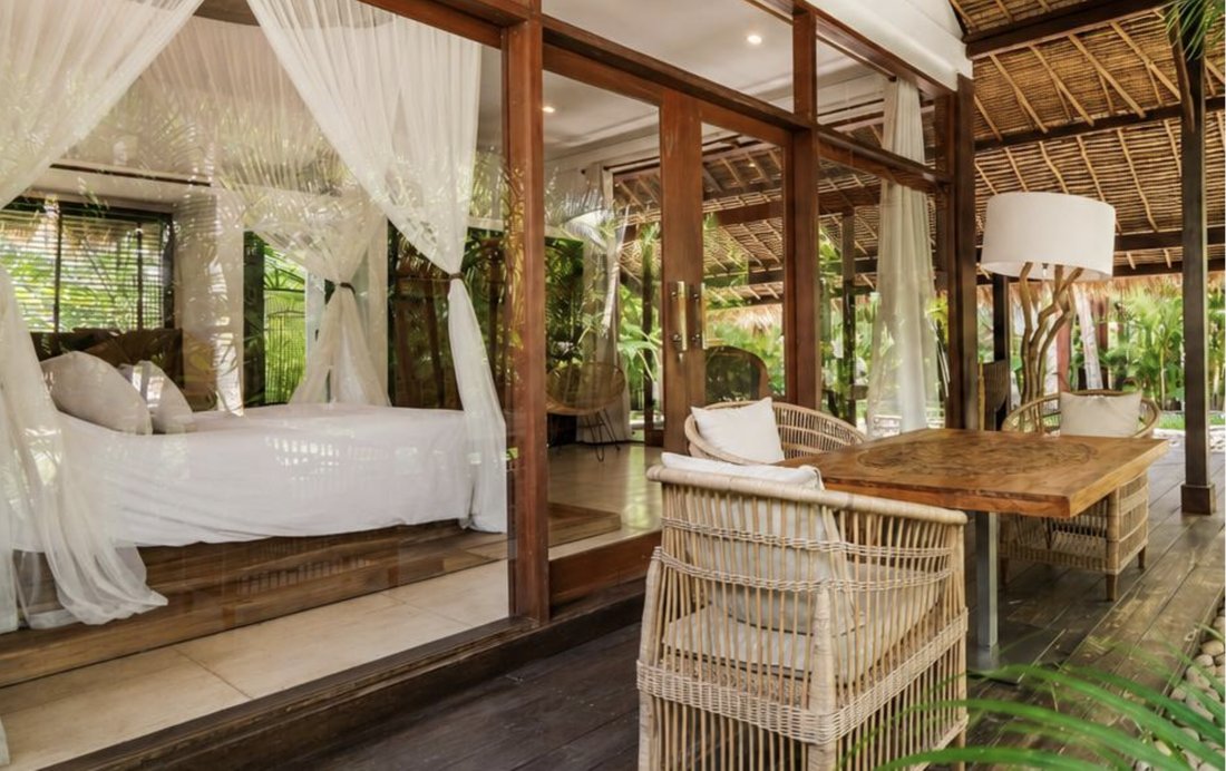 Canopy bed opening onto a covered terrace