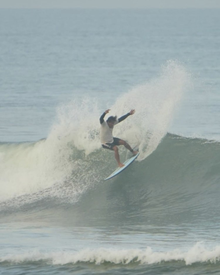 Putu catching air on a wave
