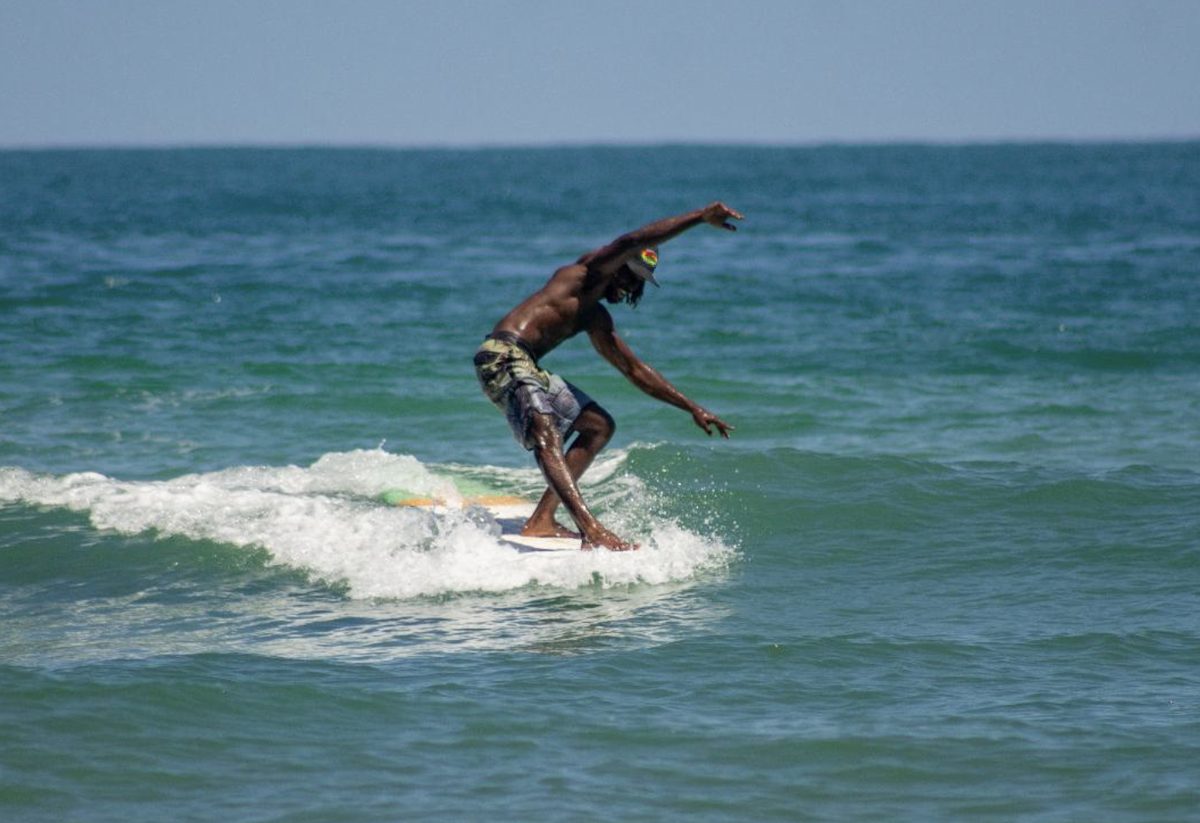 Hershel Lewis Gordon doing a bottom turn on a wave