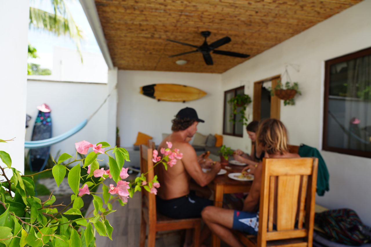 Guests eating breakfast on Coco Surf's covered porch
