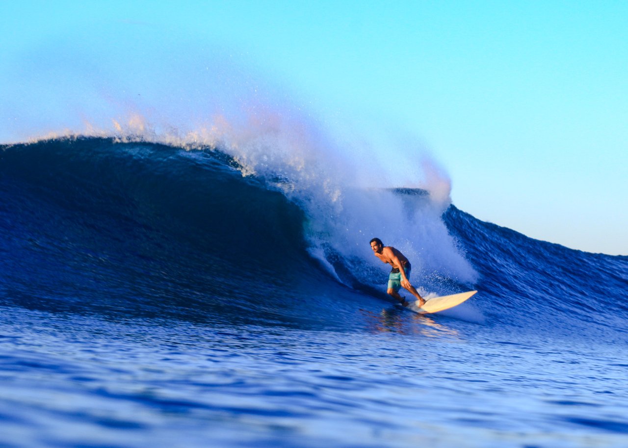 Surfer riding through a barreling wave