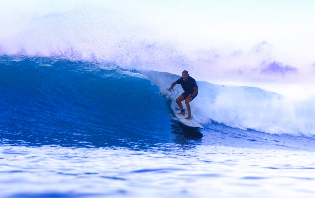 Surfer pulling into a misty morning barrel