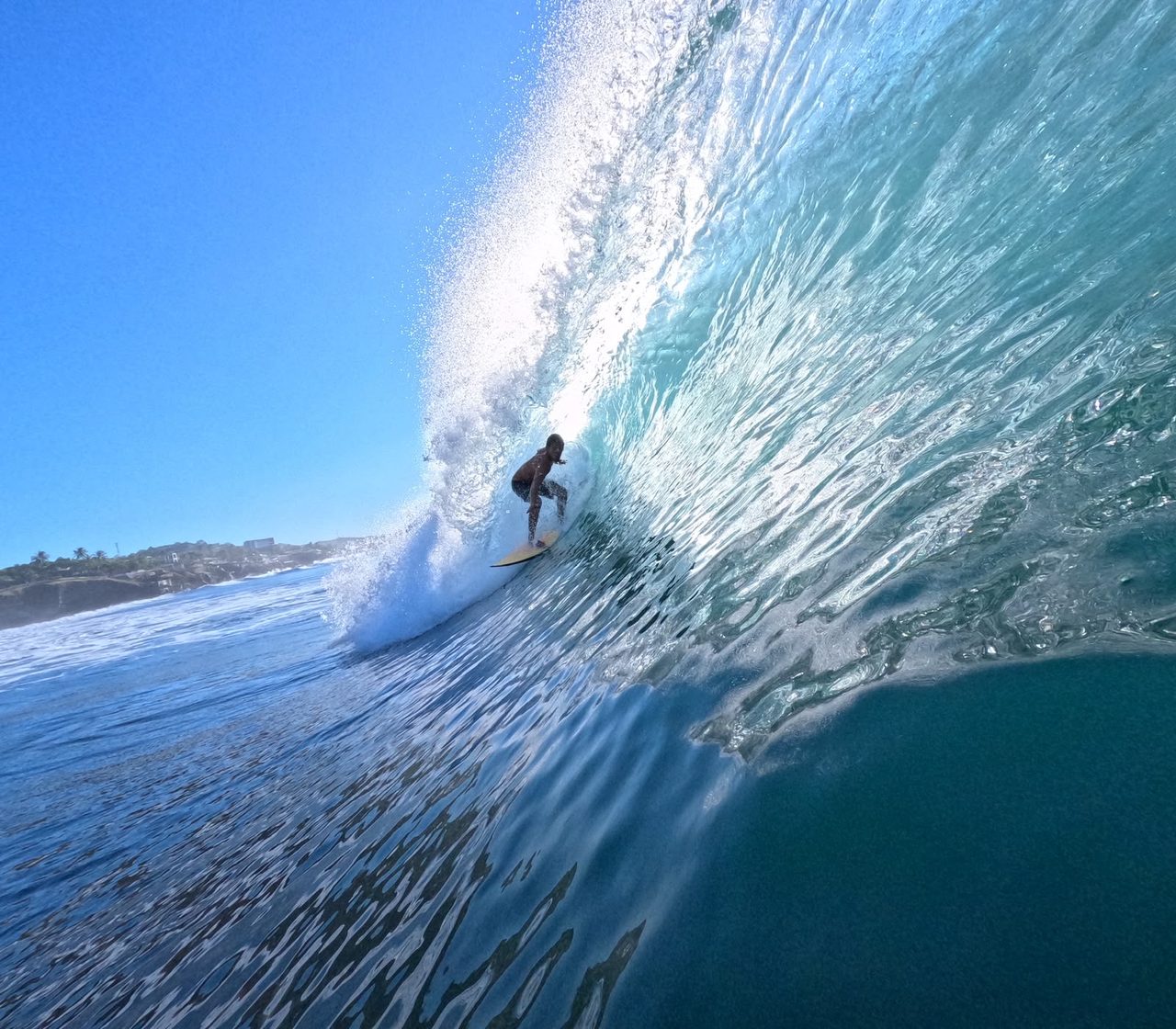 Surfer getting barreled, shot by Litoral Surf Trips