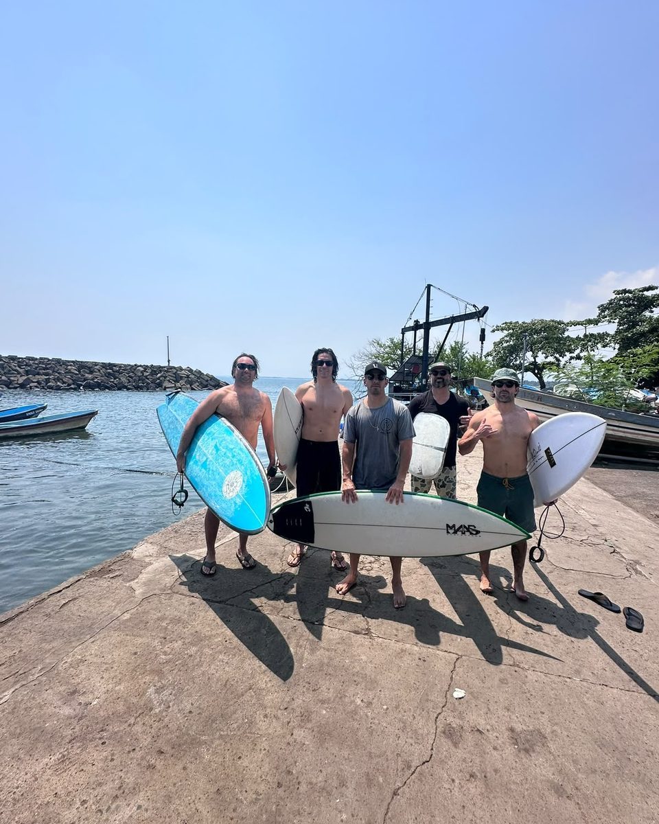 Litoral Surf Trips group with boards at the harbor