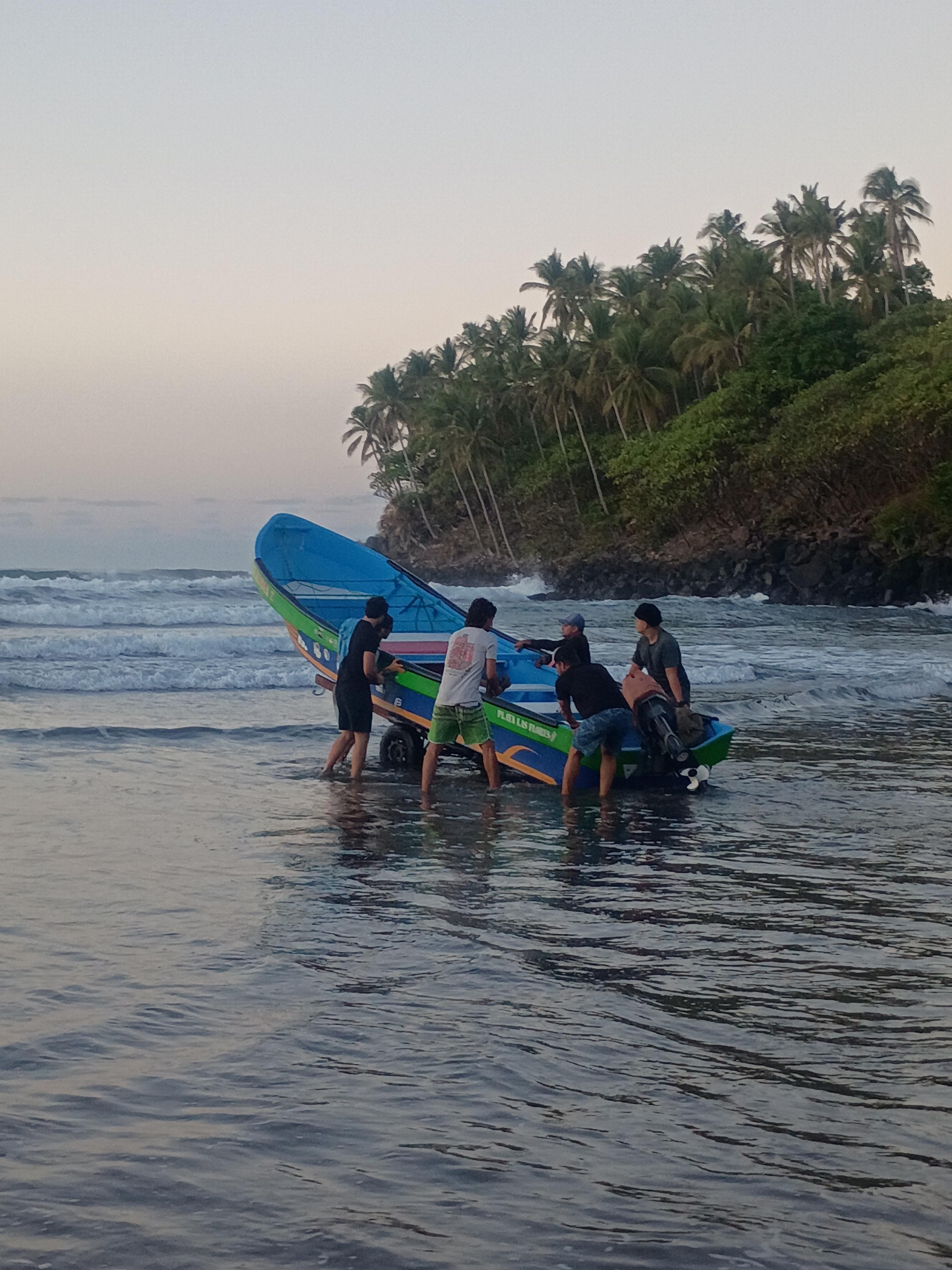 Local crew launching a panga boat near Punta Mango