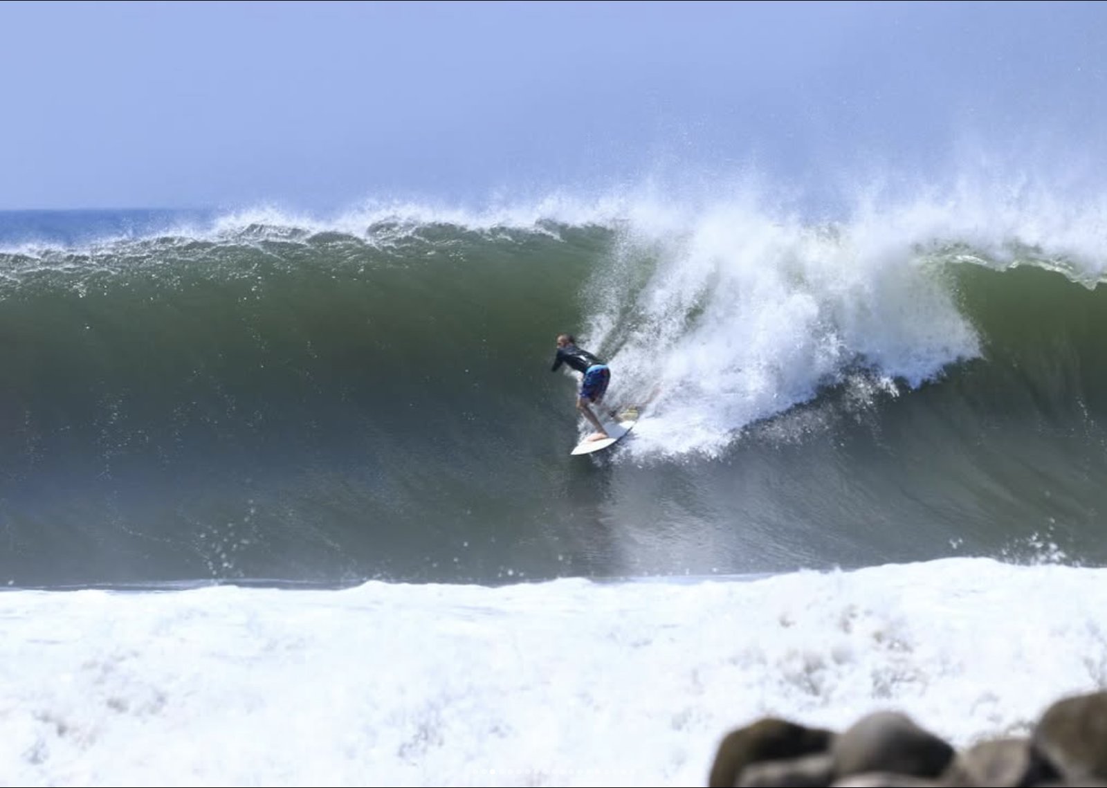 Surfer riding a wave near Rancho Agua Fria, Punta Mango