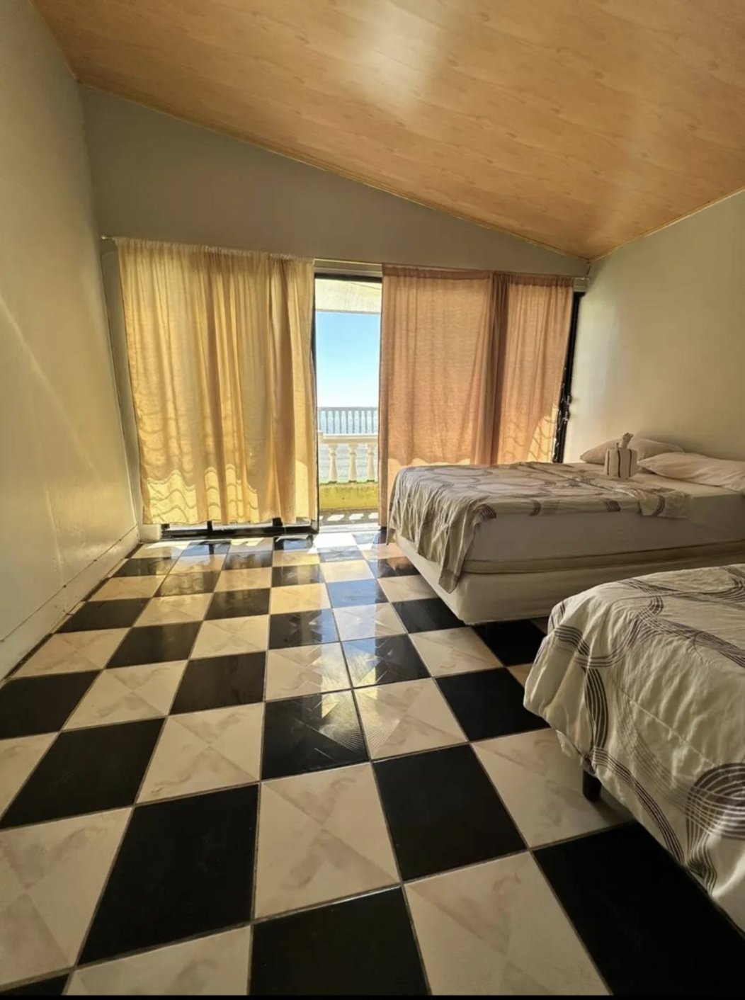 Bedroom with ocean-view balcony at Rancho Infinito Beach House