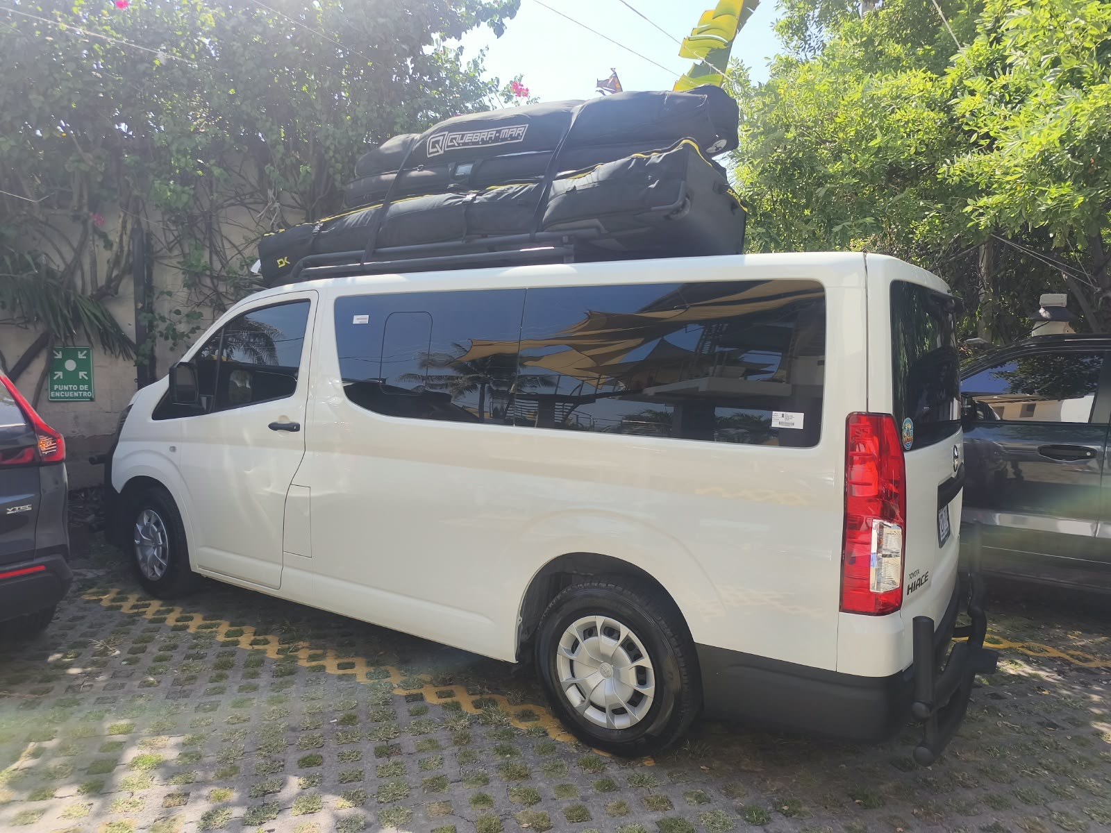 Toyota Hiace van loaded with surfboards, Victor Rivas Transportation