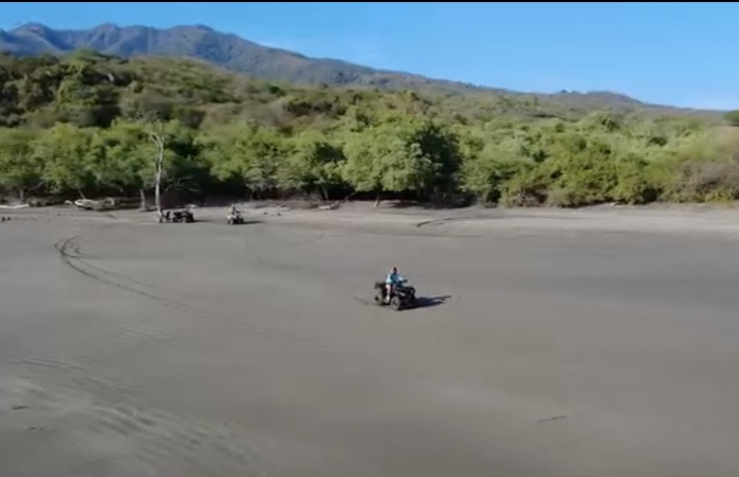 Aerial view of ATVs riding along the beach near Punta Mango