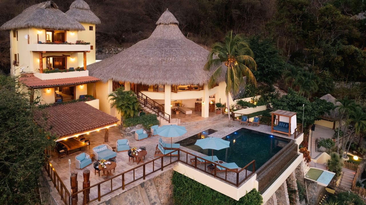 Hillside villa and infinity pool at dusk, property photography