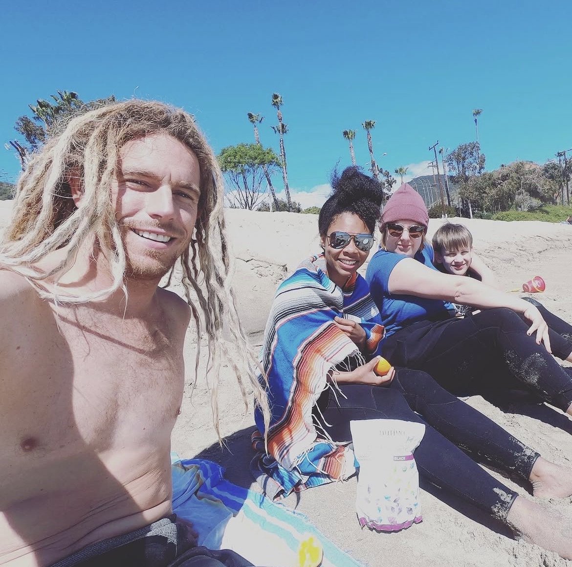 Eat Sleep Surf students relaxing on the beach after a lesson