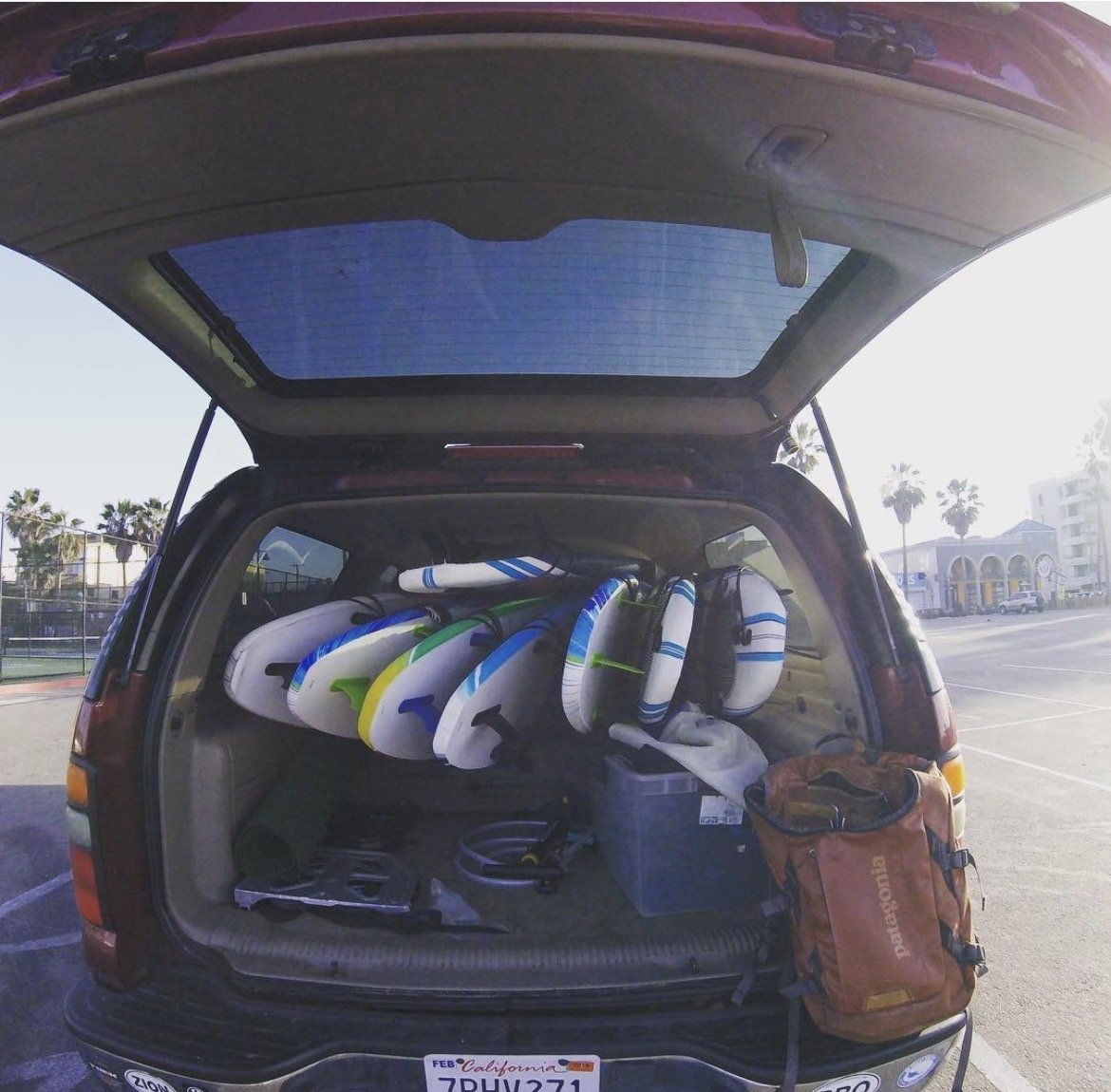 Van packed with a fleet of rental surfboards for Eat Sleep Surf lessons