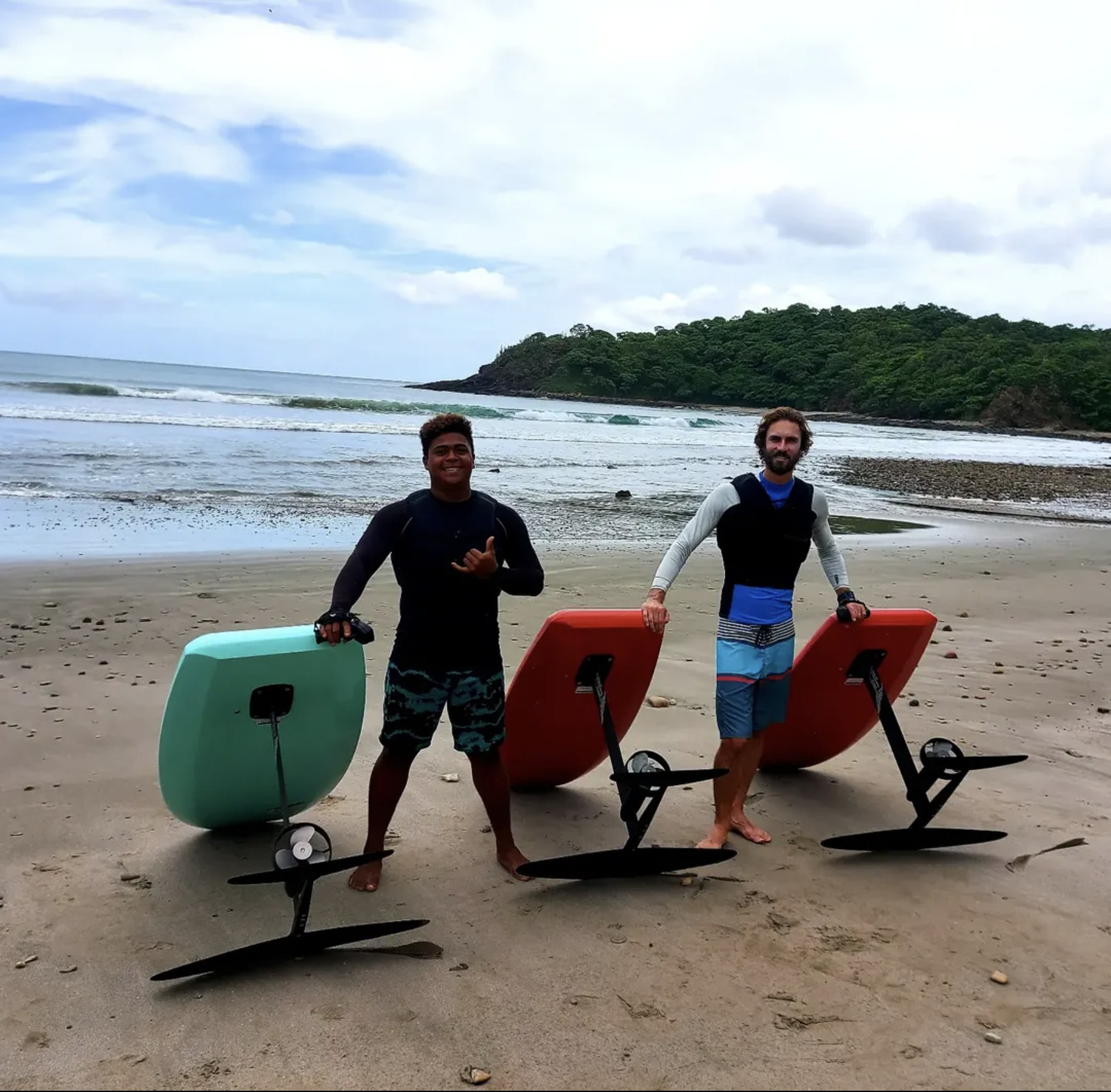 Hydrofoil boards on the beach, part of Ocean Fly Surf Shop's rental fleet