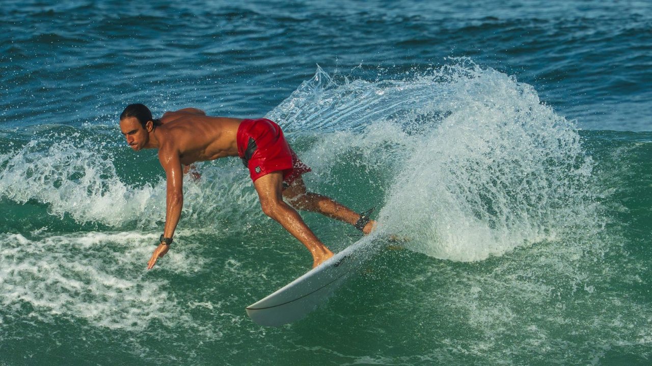 Surfer in red shorts on a bottom turn, shot by Bocas Is Love