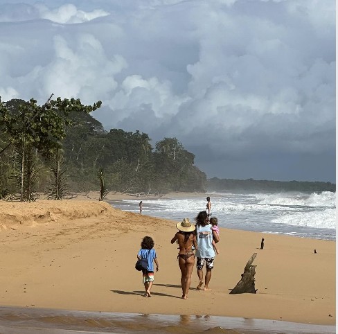 Family walking the beach near Bocas Stoked Monkeys
