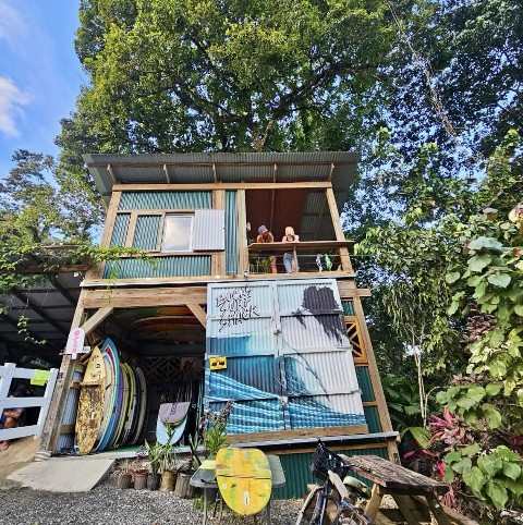 Jungle cabin exterior at Bocas Stoked Monkeys, with surfboards stored below
