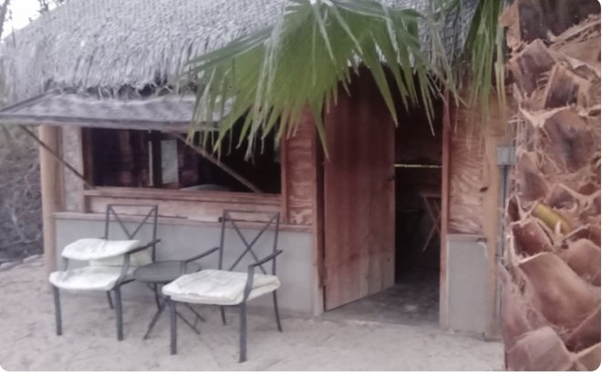 Small palapa-roofed casita with an outdoor seating area