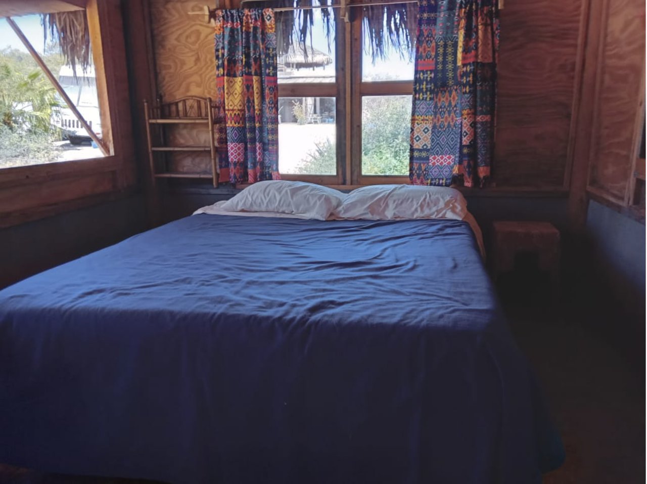 Casita bedroom with colorful patterned curtains